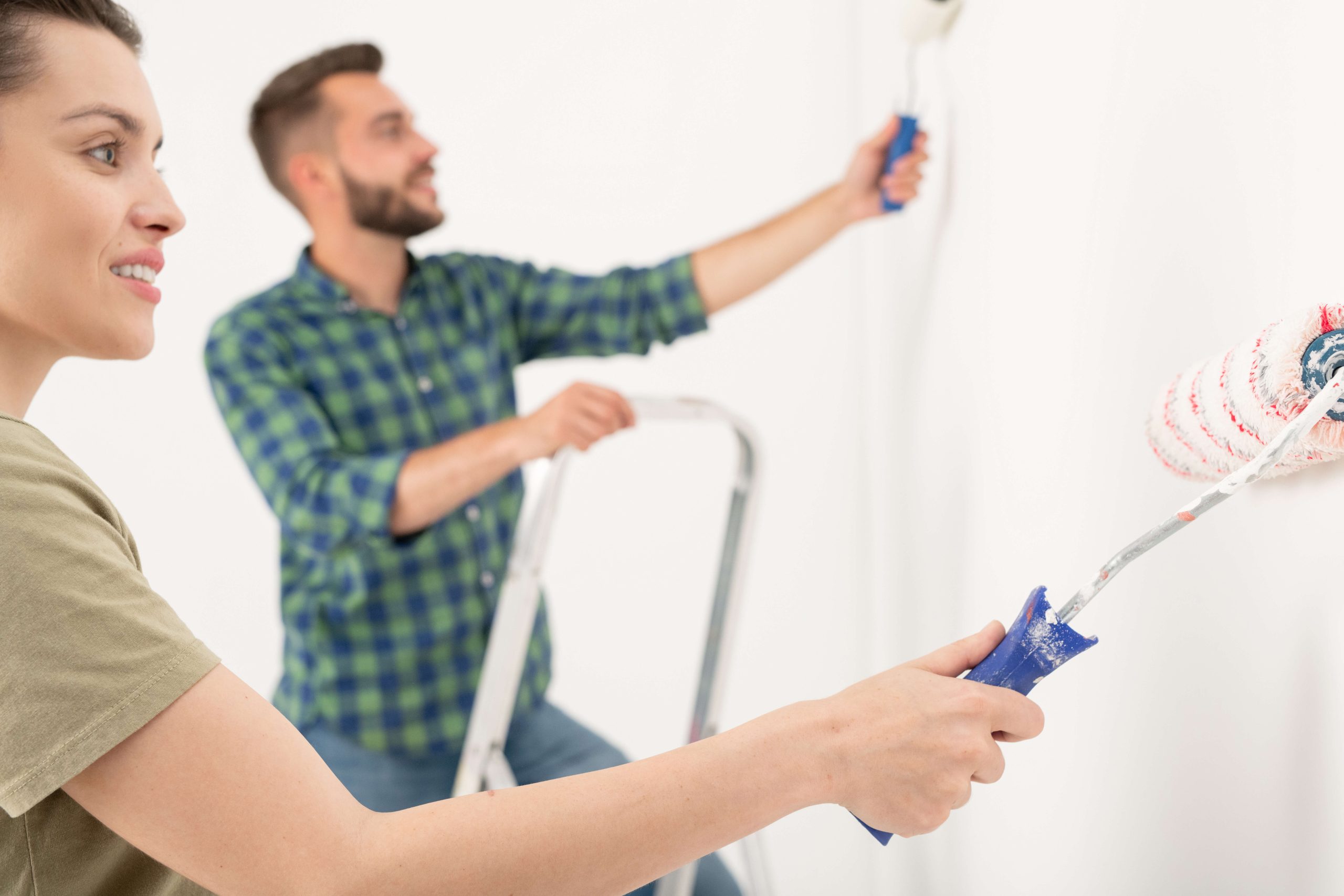 couple painting an interior room