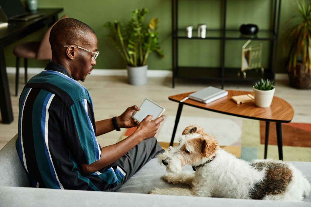 man using smart home system on tablet