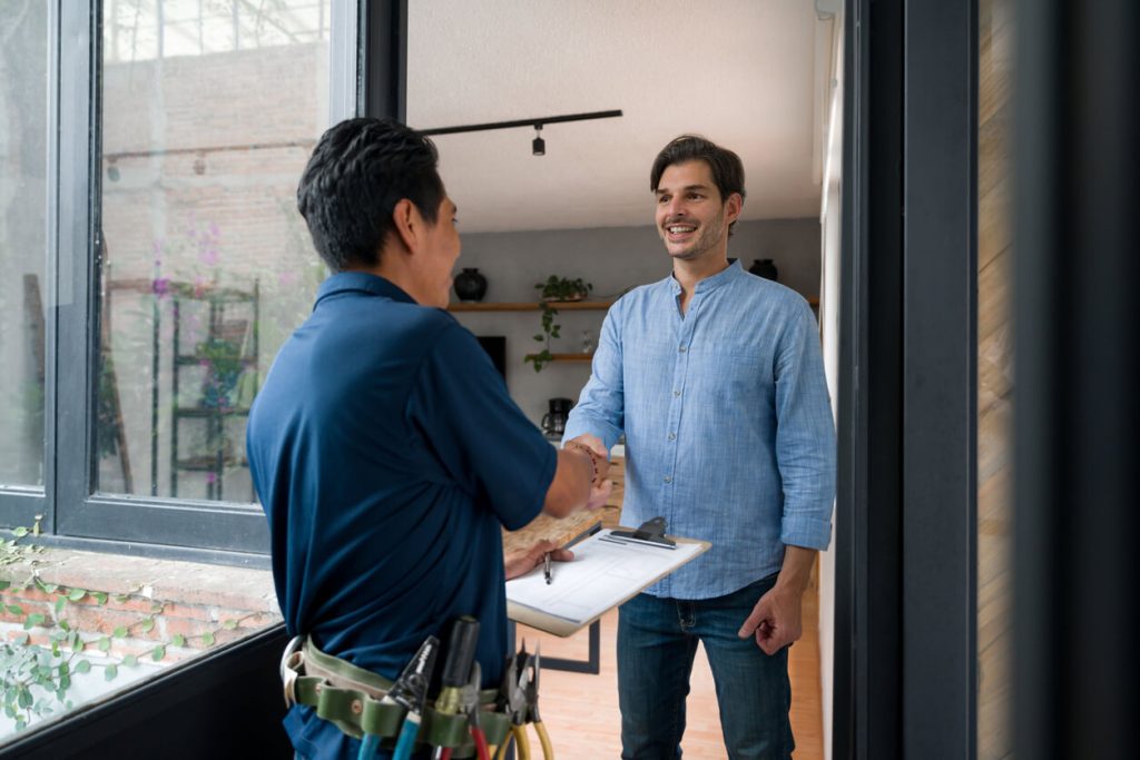 homeowner shakes hand with water softener professional