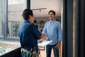homeowner shakes hand with water softener professional