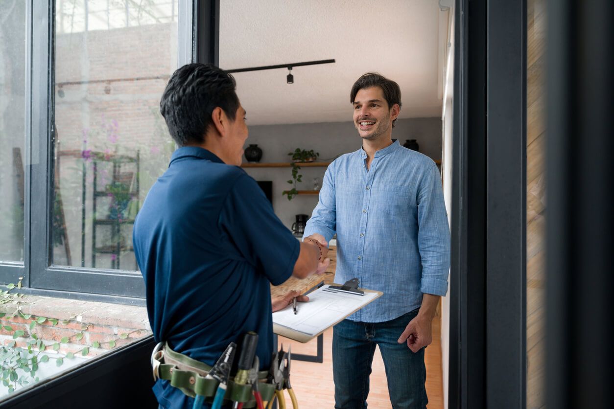 homeowner shakes hand with water softener professional