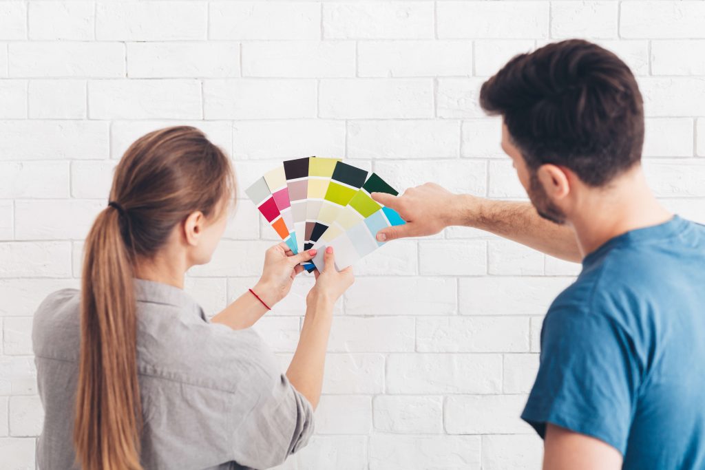 couple looking at paint samples for interior room